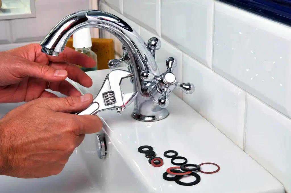 Plumber performing maintenance on a bathroom faucet in Fontana