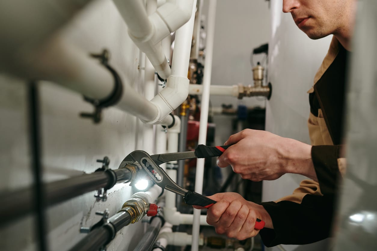 Plumbers maintaining commercial plumbing pipes in Fontana