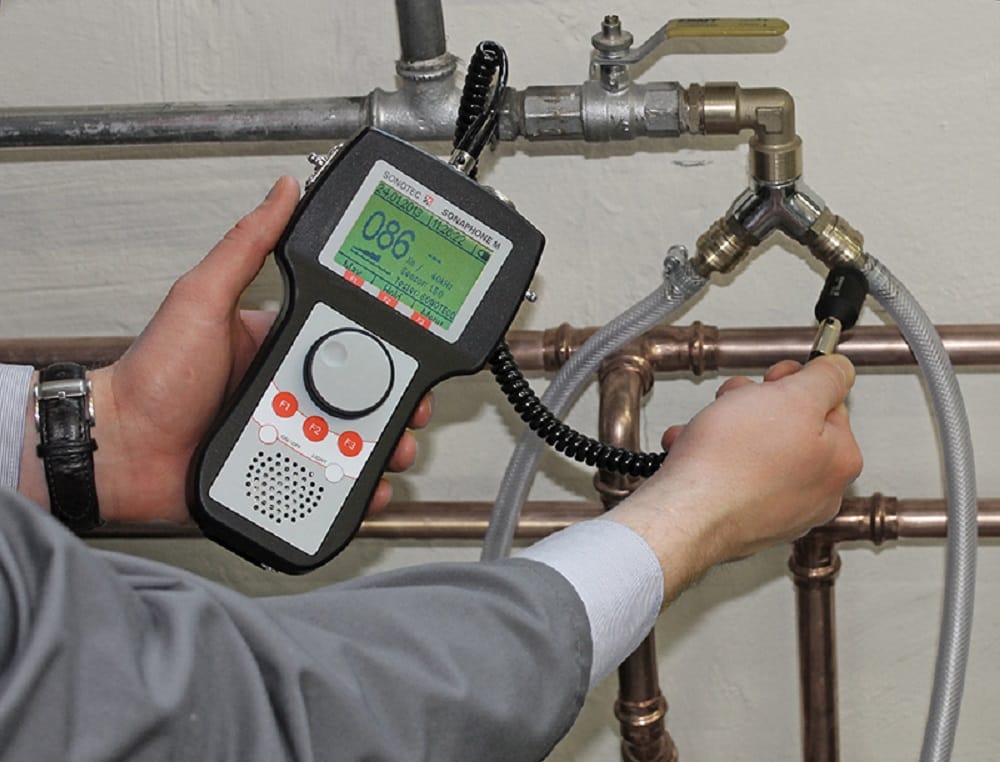 Plumber testing pipes with electronic leak detection equipment in Fontana