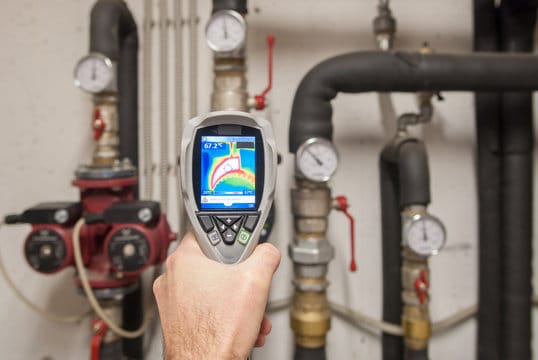 Plumber using a thermal imaging camera to inspect pipes in Fontana