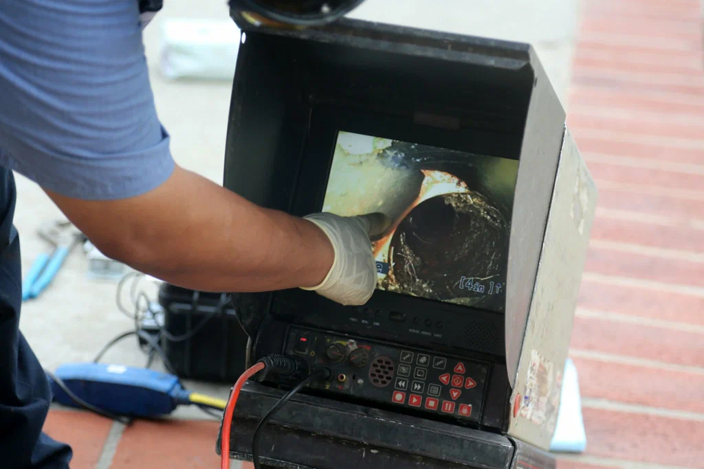 Technician viewing a drain inspection camera in Fontana