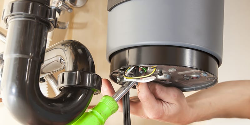 Technician repairing the heating element of a water heater in Fontana
