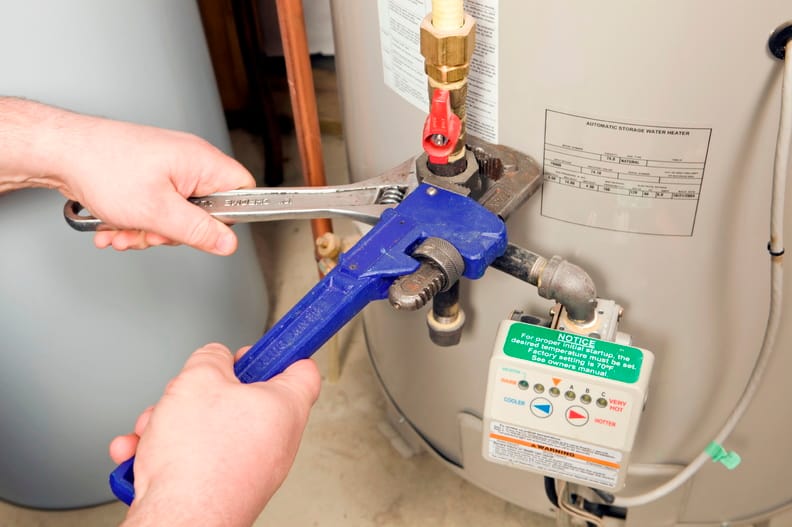 Plumber repairing a water heater valve in Fontana